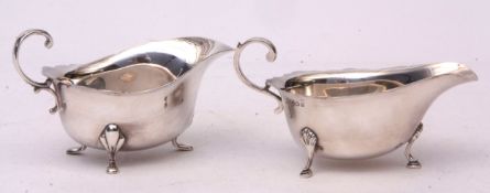 Mixed Lot: two various gravy boats both with cut card rims and applied handles on cast feet,