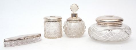Mixed Lot: four various silver mounted and clear cut glass toiletry bottles comprising powder