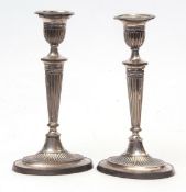 Pair of Edward VII single candlesticks, each of oval form with detachable nozzles, urn shaped