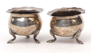 Two George V cauldron salts with cut card rims, cast and applied feet, width 5.8cms, combined weight