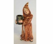 Continental pottery figure of a monk in brown glazes holding a large tankard, impressed numerals