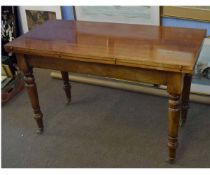 Victorian mahogany fold-over centre table raised on four turned legs with brass casters, 121cms wide