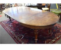 Victorian mahogany oval wind-out dining table with three extra leaves supported on tapering reeded