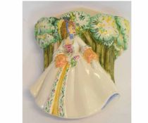 Newport Pottery wall pocket as a young girl in crinoline dress against a green ground, designed by