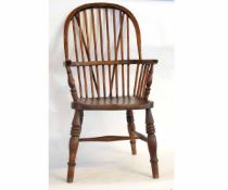 19th century elm hard seated stick back Windsor chair with ring turned front legs supported by an