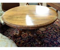 William IV rosewood circular tilt-top centre table with a heavily carved urn formed column on a