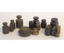 Box containing varying sized brass weights