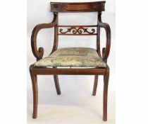 Regency mahogany scroll armchair with carved bar back, on sabre front legs and drop in seat