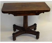 William IV rosewood fold-over card table with green baize lined interior on a turned column on a