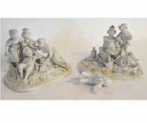 Pair of Continental Sevres style biscuit porcelain groups of children at play on flower encrusted