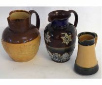 Group: three Lambeth Doulton jugs including a Harvest ware jug, a further green glazed jug and a jug