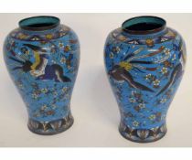 Pair of cloisonn baluster vases decorated with birds amongst flowers and foliage, 24cms high