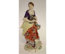 Mid-20th century German porcelain model of a shepherdess after Meissen, playing a tambourine with