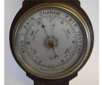 Mid-20th century oak framed wheel barometer by Barrett of Ipswich, with a silvered dial, 64cms drop