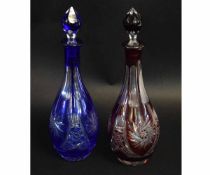 Two cut glass decanters, one with a cranberry colour, the other with blue ground, both with