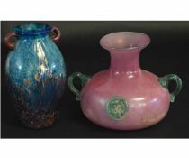 Two glass vases of Loetz style, one with a pink ground with loop handles and applied lions head to