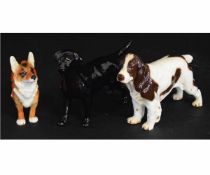 Collection of two Goebbels dogs and a Beswick dog, including models of a Labrador, Spaniel and a