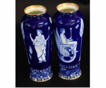 Pair of Royal Doulton ware vases decorated with blue and white Greek classical figural design,