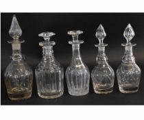 Group of five mid-19th century cut glass decanters, including two with diamond shape stoppers, and a