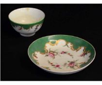 Worcester tea bowl and saucer, the green ground decorated with floral sprays, saucer 12cms diam