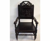 Victorian Gothic oak armchair with carved back panel and hard seat on a barley twist stretcher