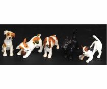 Collection of five Royal Doulton figures of dogs including three puppies with various poses, a