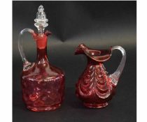 Cranberry glass decanter and stopper, together with a moulded cranberry coloured jug, decanter 25cms