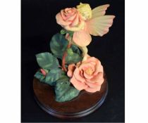 Model of roses on a wooden base by Border Fine Arts, the roses coloured in pink and yellow
