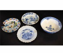 Group of English Delft ware and a porcelain bowl comprising three plates and a bowl, all with