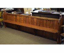 Victorian pitch pine pew, 11ft in length, with carved finials to either end