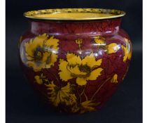 Royal Doulton jardiniere, decorated with a rouge body with yellow detailed flowers with a black