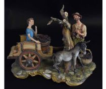 Capo di Monte model of grape pickers with a boy kneeling on the back of a cart with a bucket of