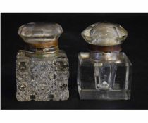 Two 19th century clear glass square formed inkwells with hinged lids, each 6cms square x 9cms tall