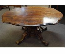 William IV rosewood lobed formed tilt-top centre table with a heavily carved fluted and scrolling