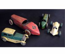 Group of four vintage tin racing cars to include a saloon car, a England made red and cream racing