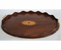 Edwardian mahogany tray of oval form, applied at either end with brass handles and with central