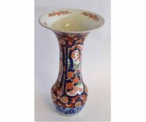 Large Japanese Imari style vase with a central panel of flowers in blue and iron red, rising to a