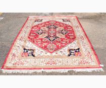 Good quality modern Heriz carpet decorated in a cream ground with a central rust lozenge with floral
