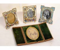 Group of three decorative flower encrusted photograph frames, together with one other (4)