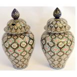 Two large Oriental ginger jars and covers, with polychrome decoration, the covers with large plum
