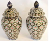 Two large Oriental ginger jars and covers, with polychrome decoration, the covers with large plum