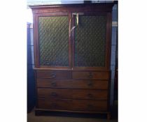 Regency style mahogany linen press, the upper doors with brass grilles enclosing fitted slides and