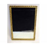 Late 20th century rectangular wall mirror with gilt frame with repeating design and bevelled