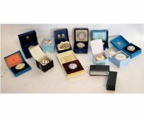 Eleven assorted boxed enamel and porcelain pill boxes by Halcyon Days, Bilston and Battersea