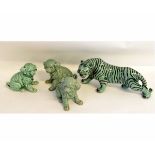 Oriental model of a tiger with black stripes on a celadon ground, together with three puppies with a