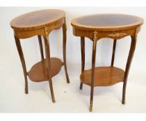 Pair of oval European two-tier occasional tables with gilt metal mounts, each 57cms wide