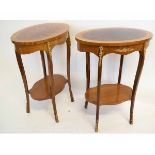 Pair of oval European two-tier occasional tables with gilt metal mounts, each 57cms wide