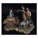 Capo di Monte model of grape pickers with a boy kneeling on the back of a cart with a bucket of