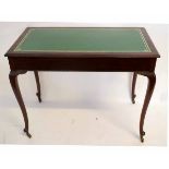 Early 20th century mahogany two-drawer writing table with gilt tooled green inset and cabriole legs,