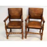 Pair of early 20th century oak framed leather upholstered open armchairs